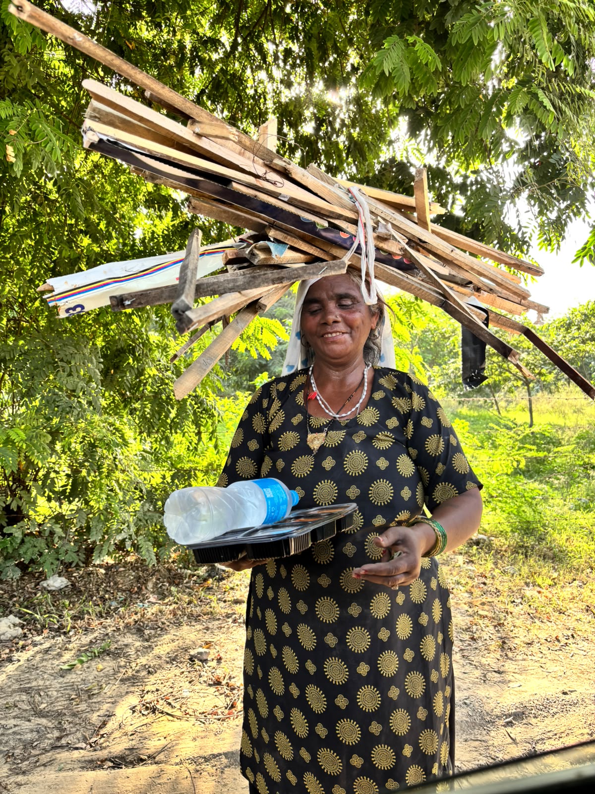 A woman carrying food and drinking water support